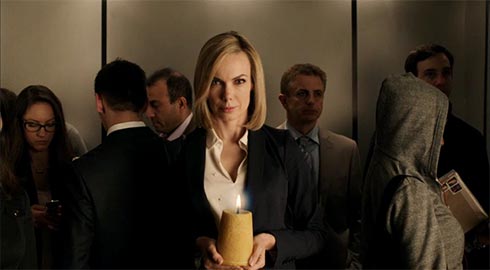 woman in elevator holding a candle