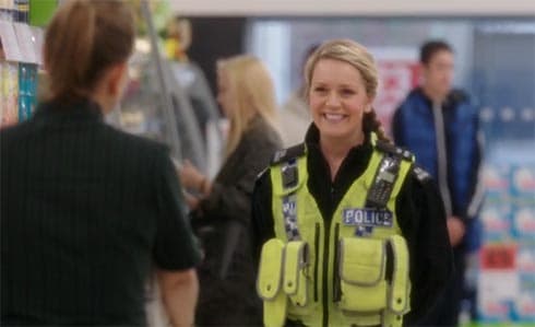 Cheryl in her cop's uniform.