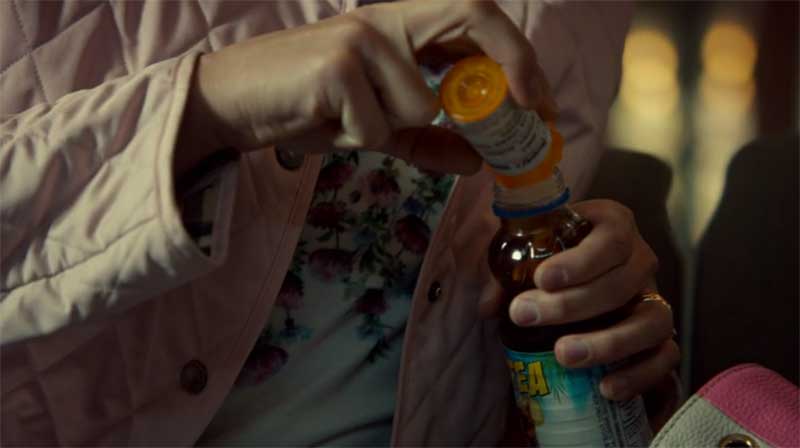 Alison pours pills into a drink