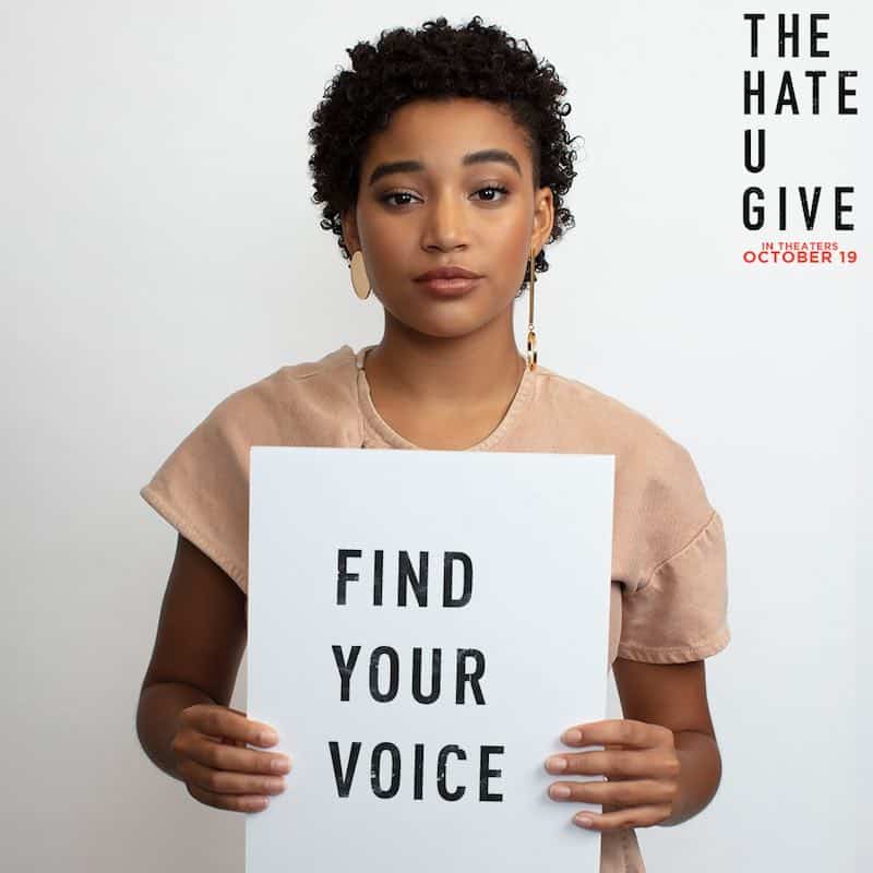 Amandla Stenberg holds a sign that says Find Your Voice in an ad for The Hate U Give