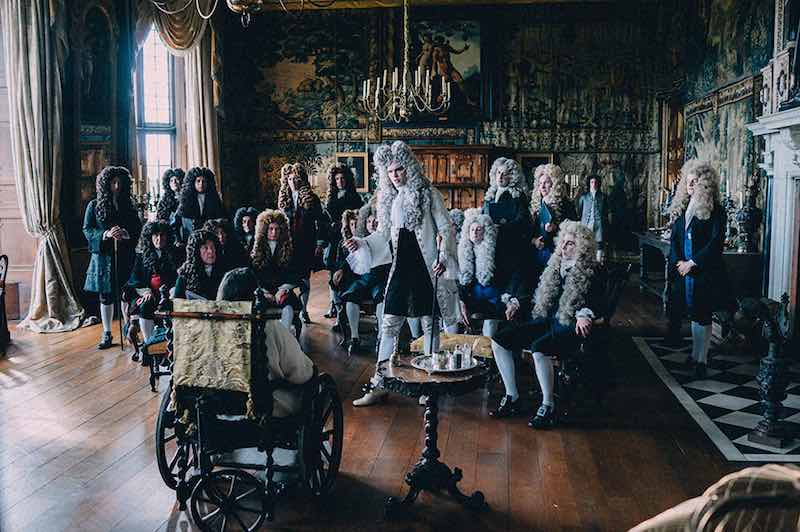 Nicholas Hoult in the center of the frame as Harley in The Favourite