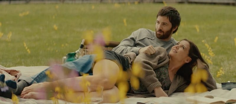 Katie Holmes and Jim Sturgess lie on a blanket outside in Alone Together