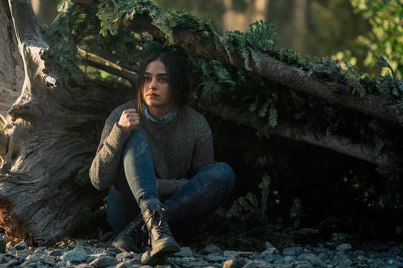 Melissa Barrera shelters under a fallen tree in Keep Breathing